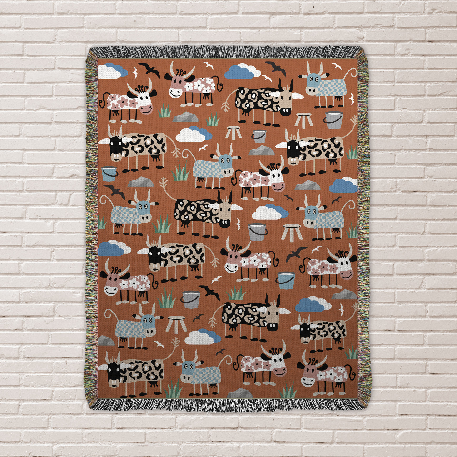 Whimsical Cows Woven Cotton Blanket, hung on a wall
