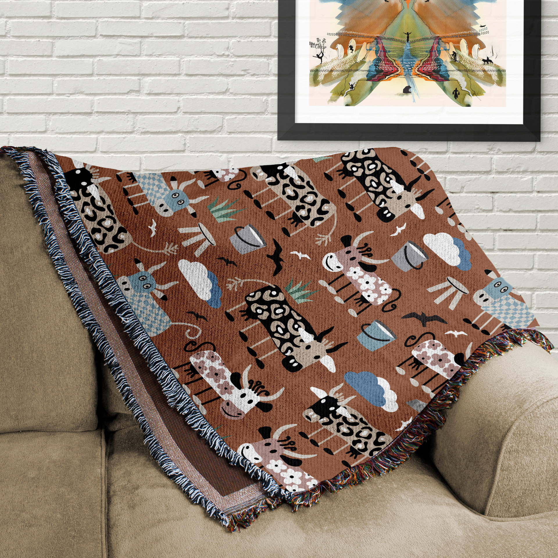 Whimsical Cows Woven Cotton Blanket, folded on a couch