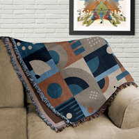 Blue and Brown Abstract Geometric Shapes Woven Cotton Blanket folded on a couch