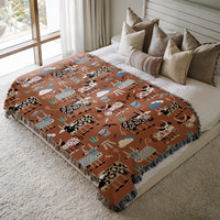 Whimsical Cows Woven Cotton Blanket, on a bed